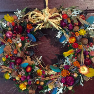 Wayside Wheel - ©Pat Tuholske - Native Grasses, Everlasting Flowers, Honey Locust Pods, Birch Bark, Artemisia, Lavender, Acorns, Spruce Cones, Moss and Feathers on wayside wild plant base - 15” diameter - $85