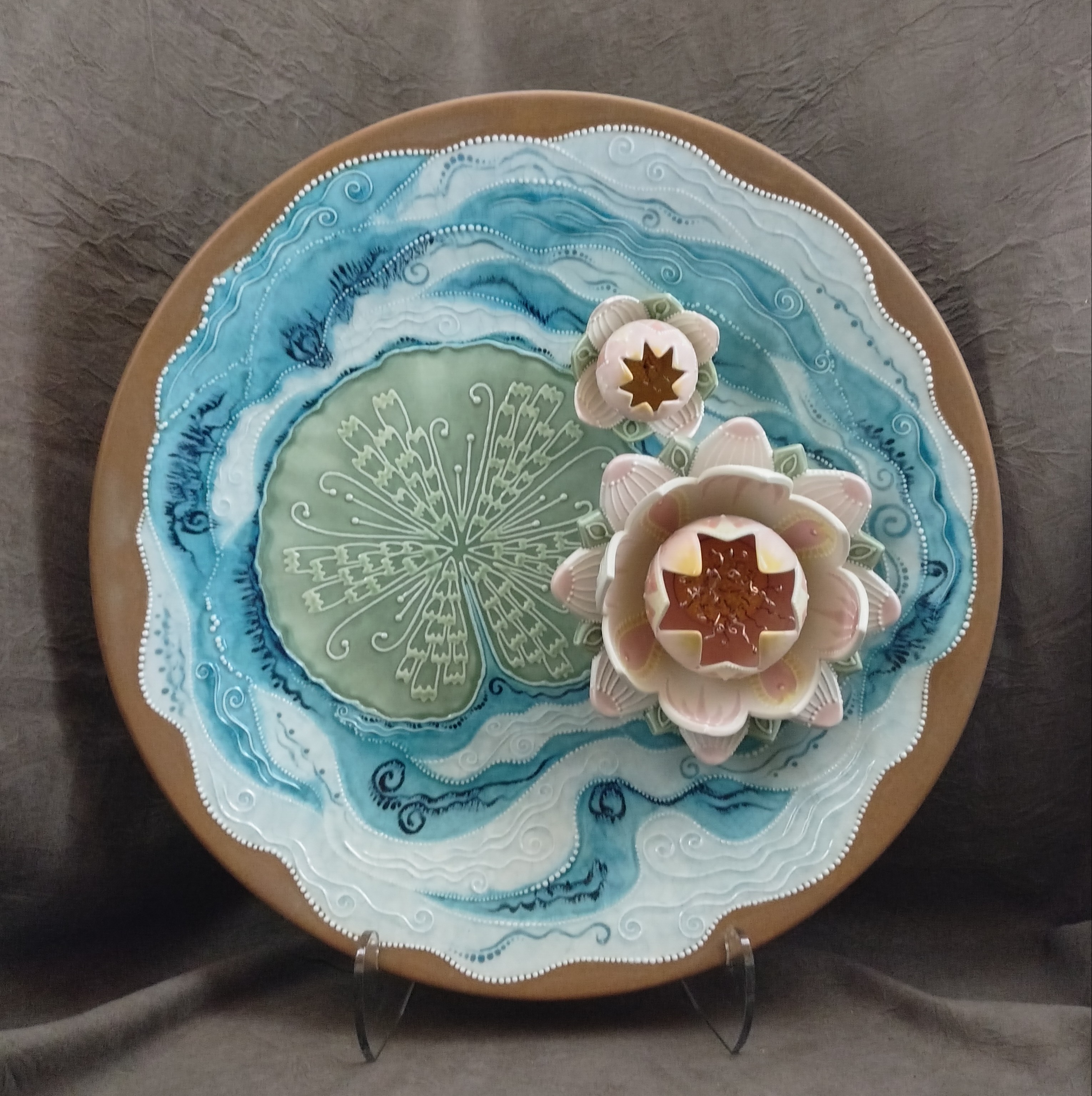 Lily Pad - © Stephanie Barken - Cut and glazed ceramic, copper wire - 20 diam. x 3.5 deep, 21.5 high in stand (included) - 525