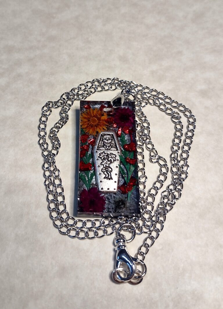 Part # 147210096 Resin Day of the Dead Pendant Necklace with a stainless steel chain Length 20 inches Price $24.71