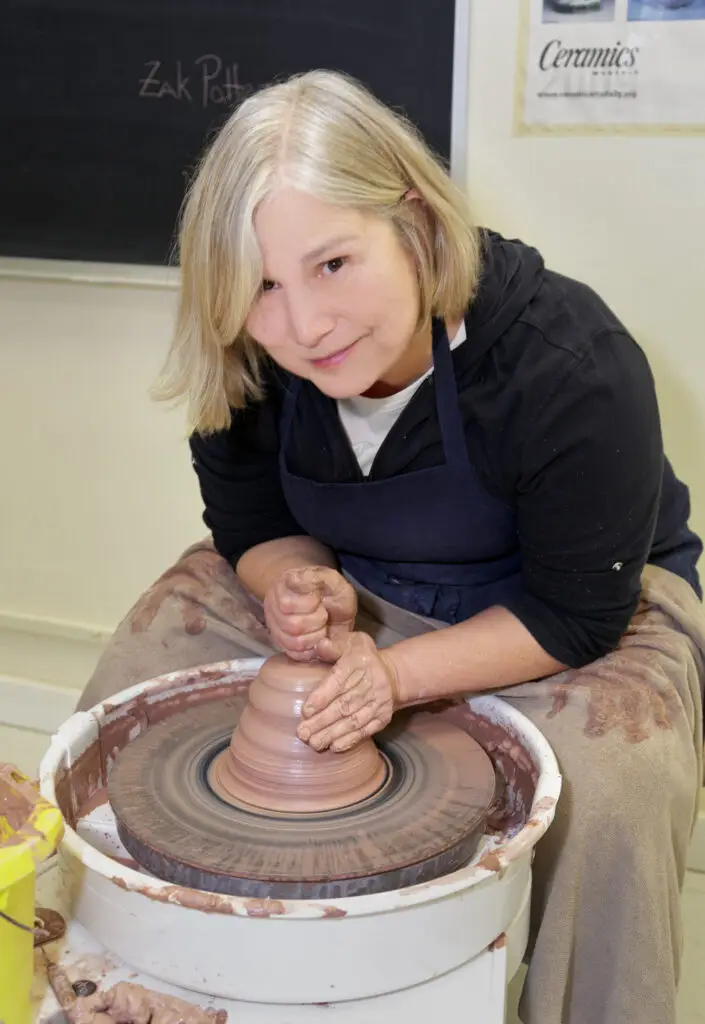 Sandra Zak working at a pottery wheel